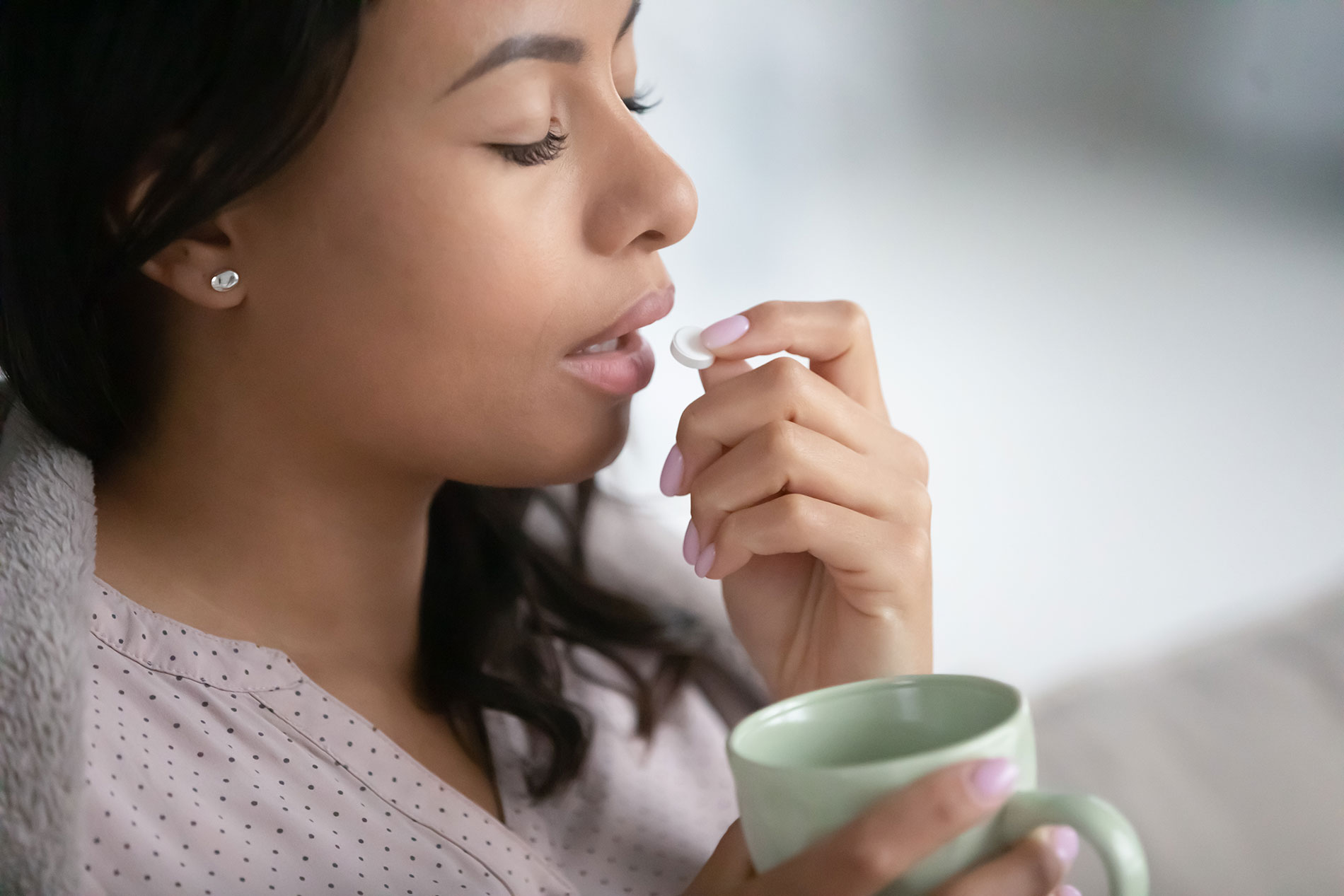 sick person taking prescription pill